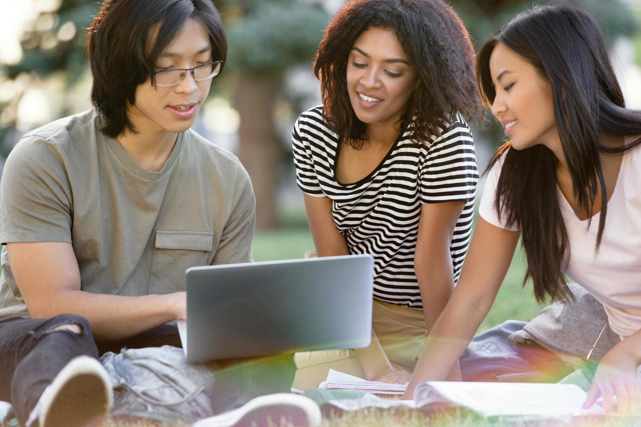 A team of cheerful friendly learners of high school standing together and smiling
